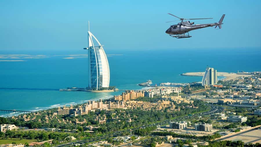 Dubai: Helicopter Ride, Old Town Walking Tour, Abra & Snacks - Moving from the heliport to Old Dubai